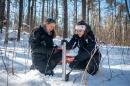 Two female researchers working in a snowy field